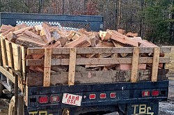 Our reliable delivery truck packed with premium firewood for prompt service.
